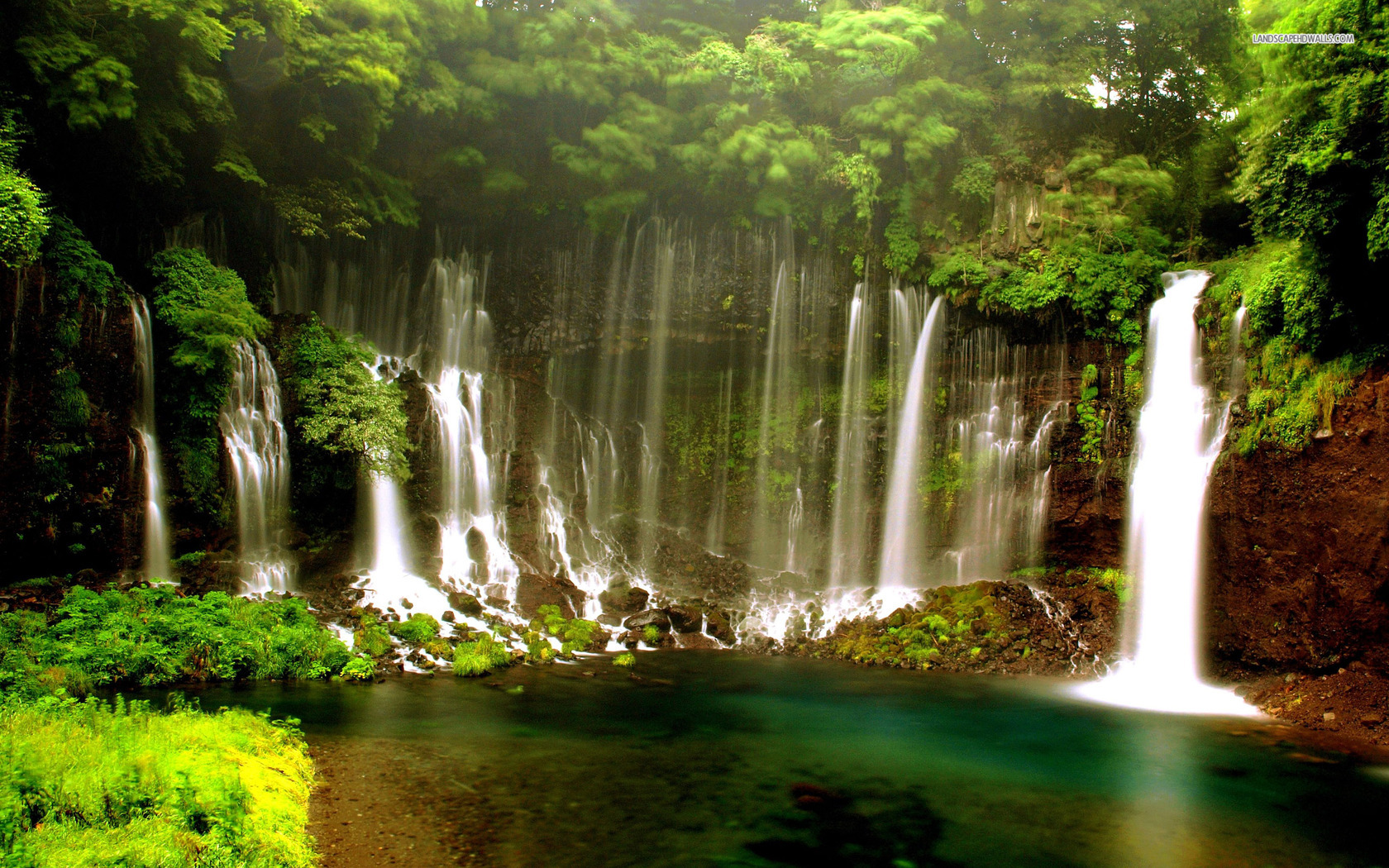 Small waterfalls in the summer forest wallpaper