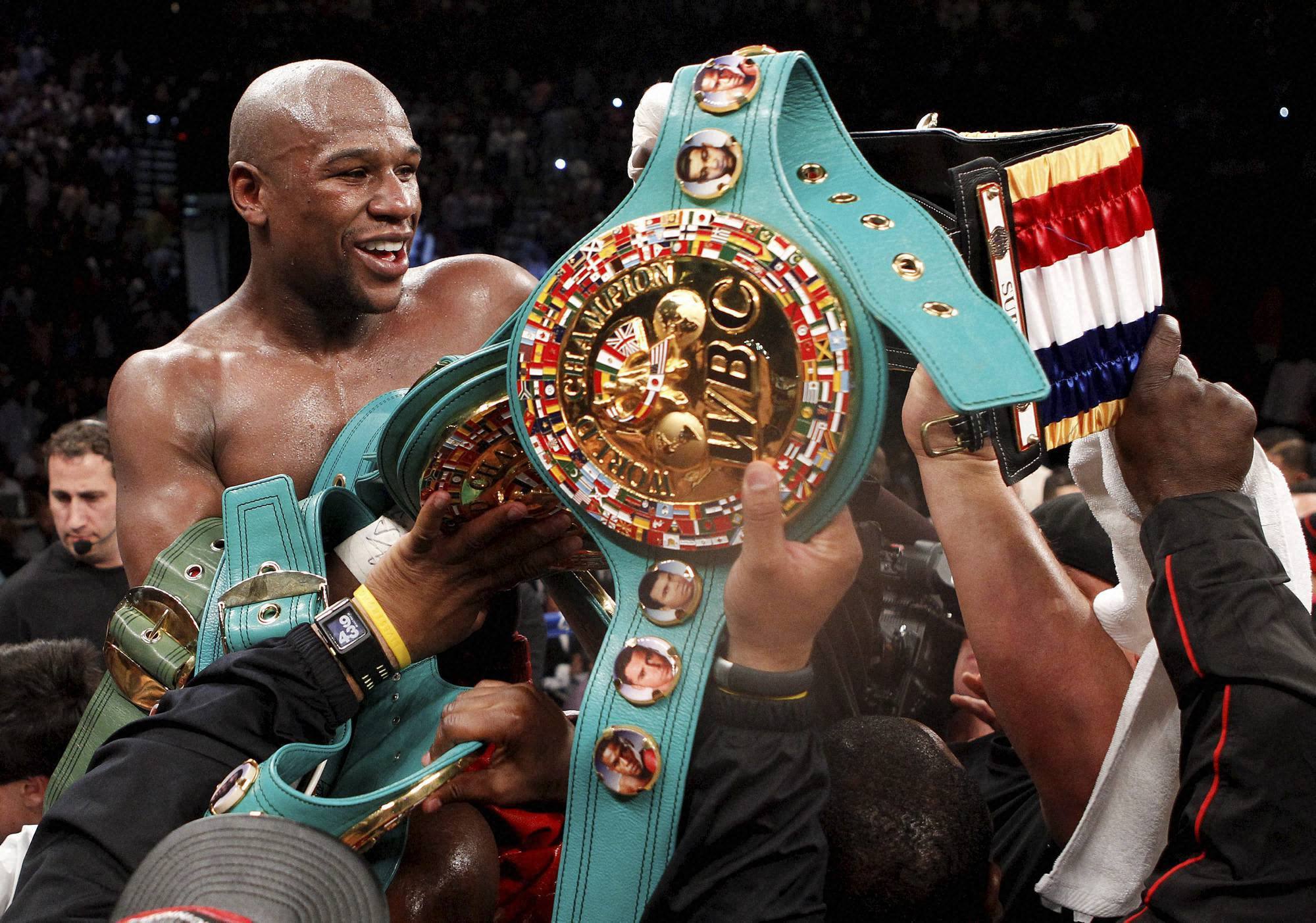 Boxer Floyd Mayweather Jr and his prizes wallpapers and images