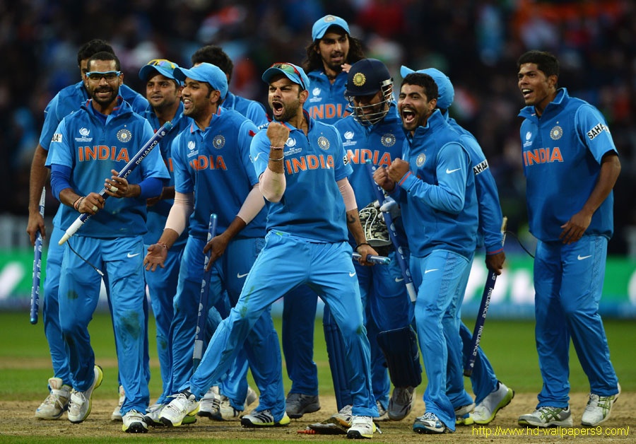 The victorious Indian team pose behind the Champions Trophy banner ...
