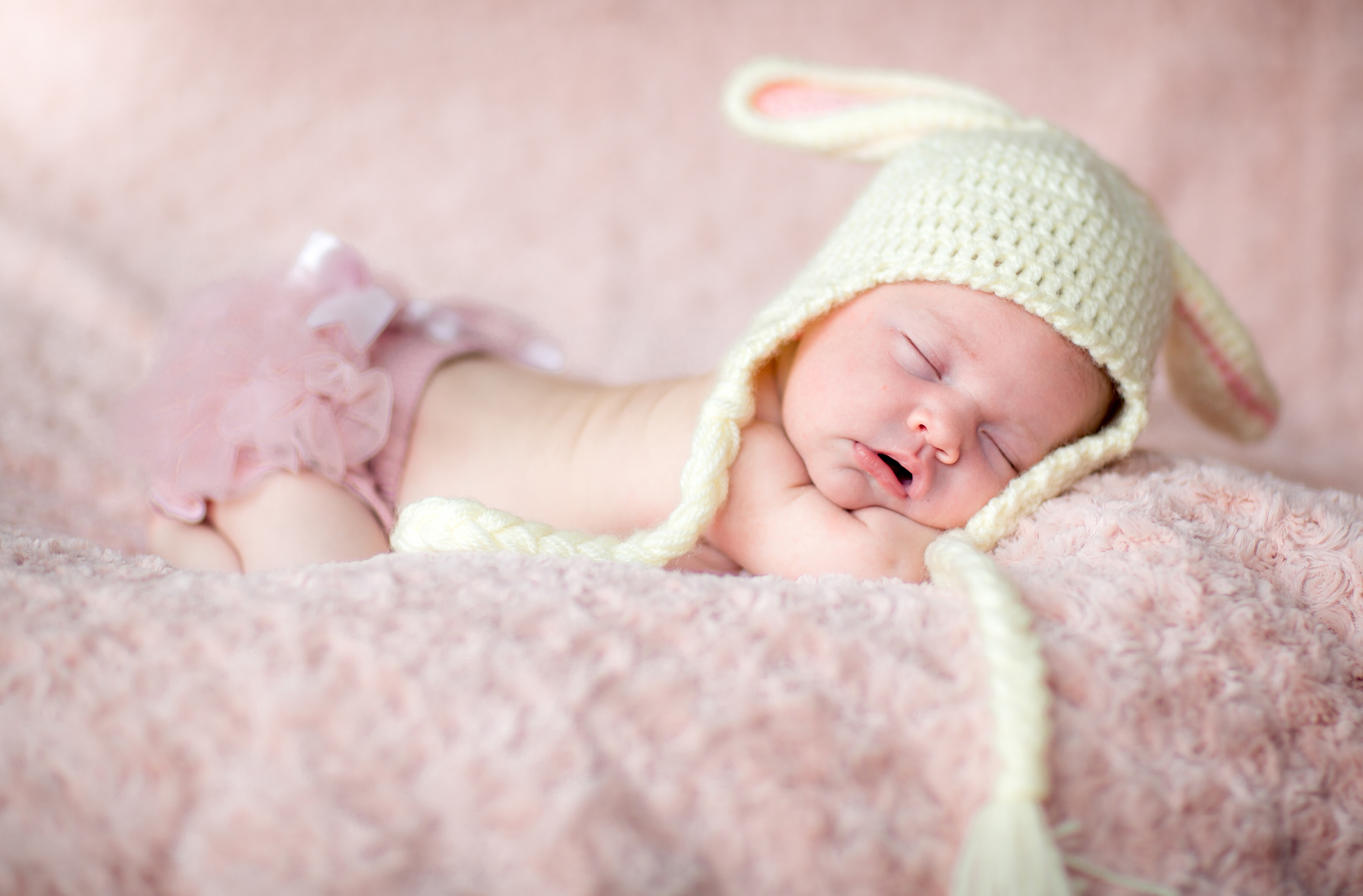 cute newborn baby girl sleeping picture on pink carpet