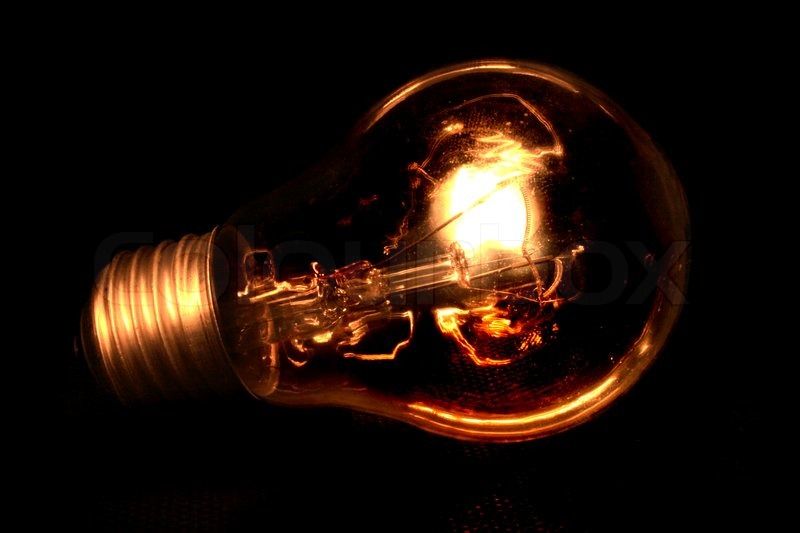 Light bulb isolated on the black background | Stock Photo | Colourbox