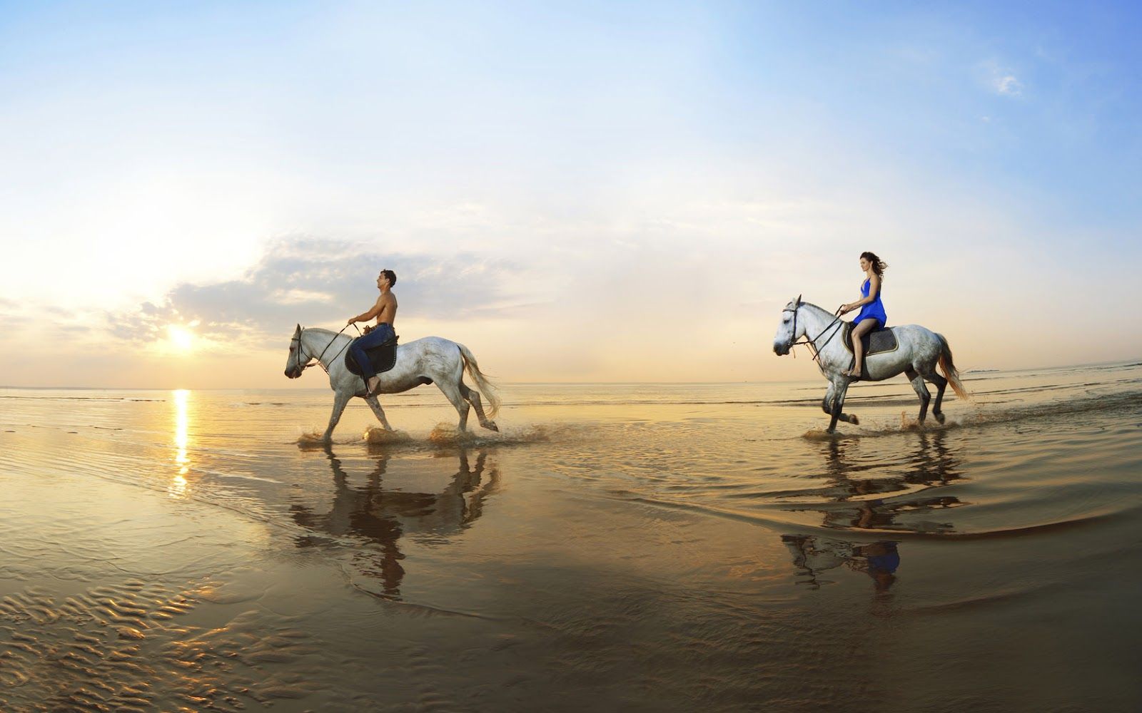 Two people horseback riding on the beach ~ Trends Wallpaper